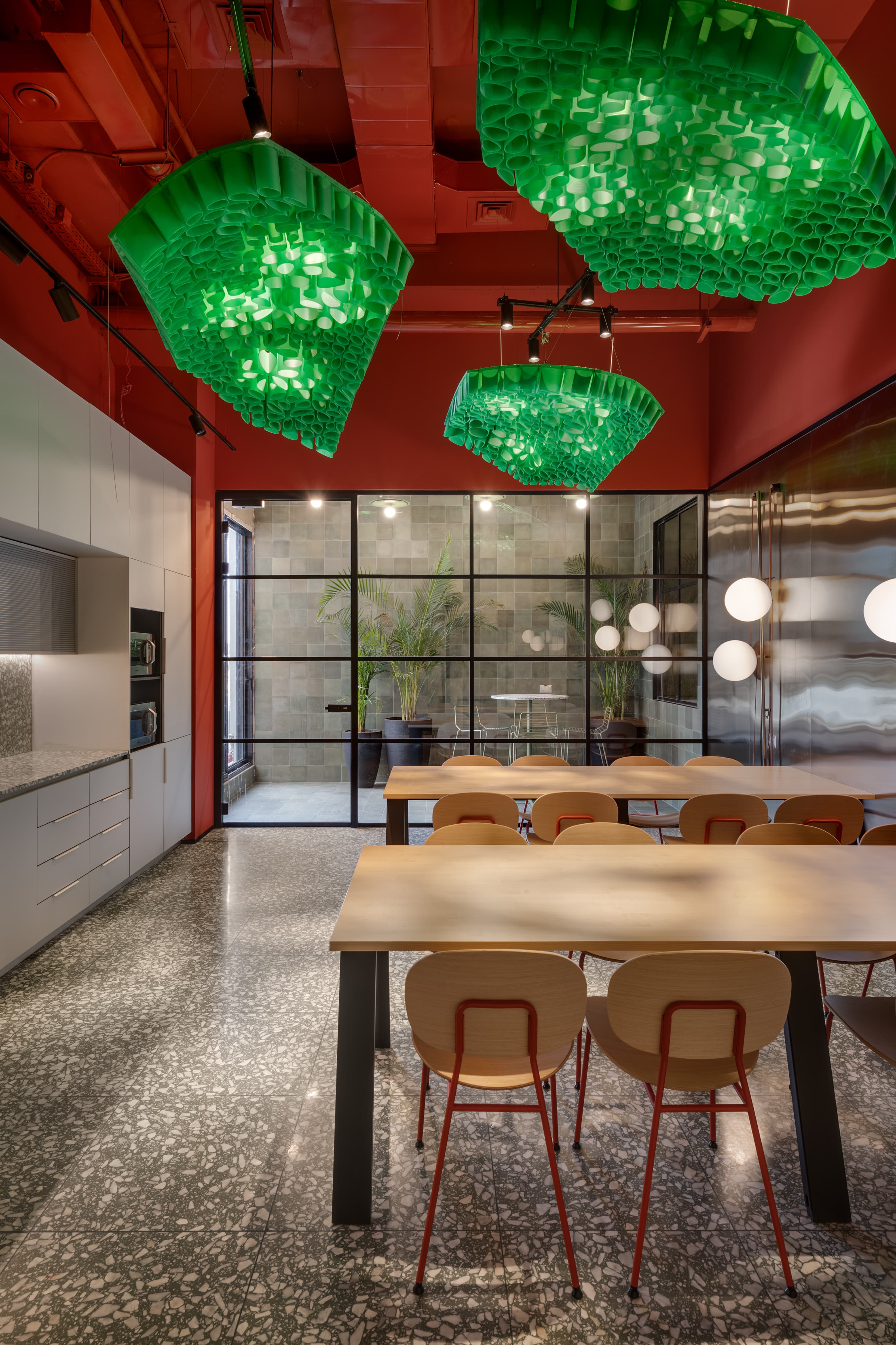 Tel Ad Office — kitchen dining area with green chandeliers