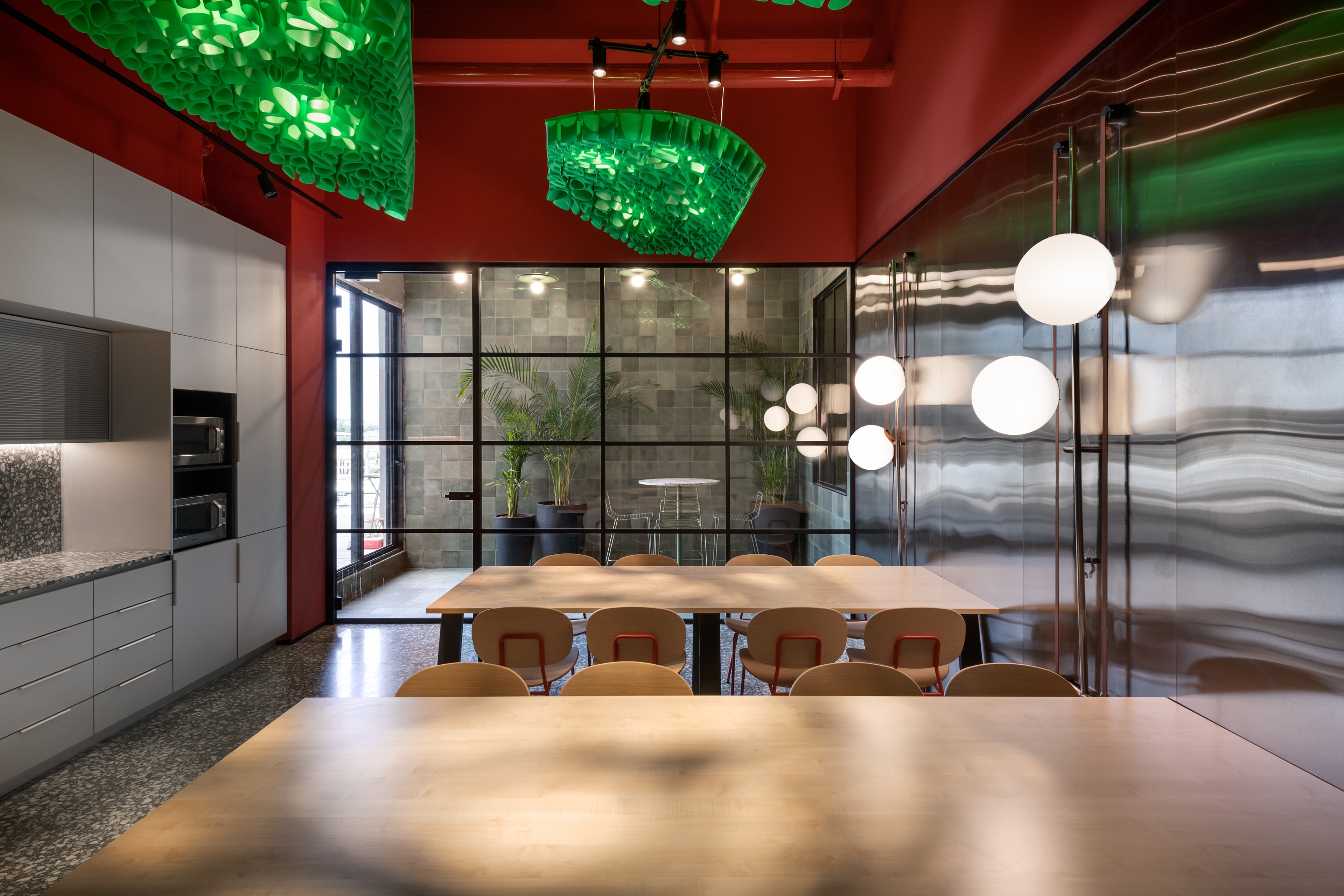 Tel Ad Office — kitchen overview with planted patio beyond