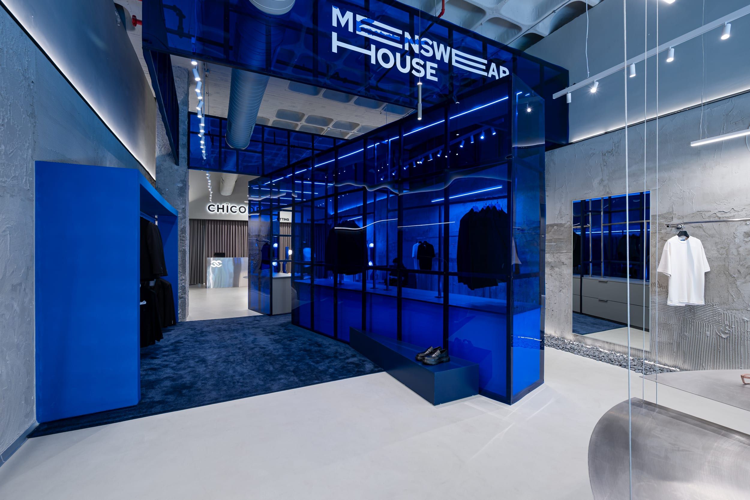 Blue glass volume corner with the Menswear House signage