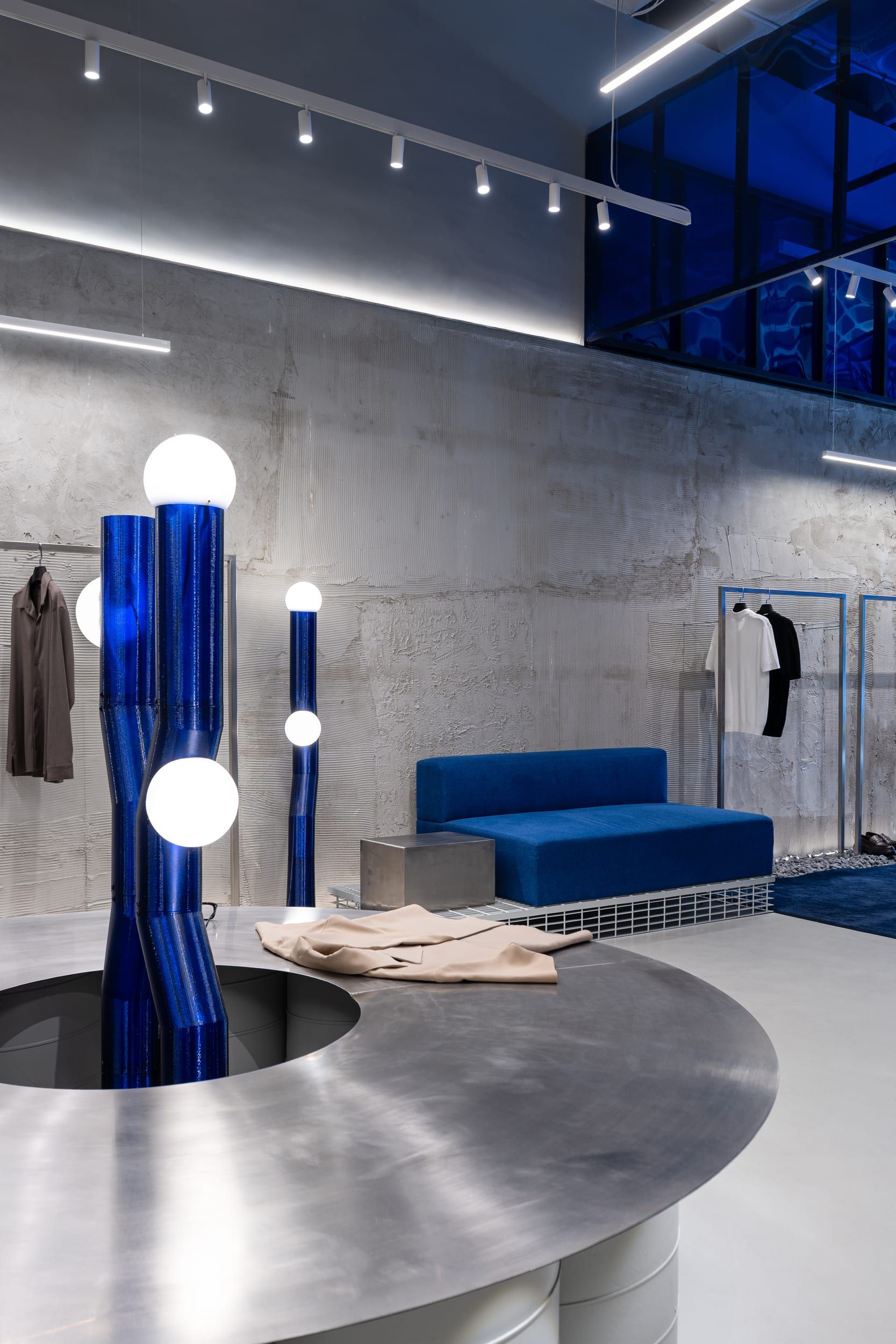 Vertical view of the custom 3D-printed blue lamp sculpture beside the display island