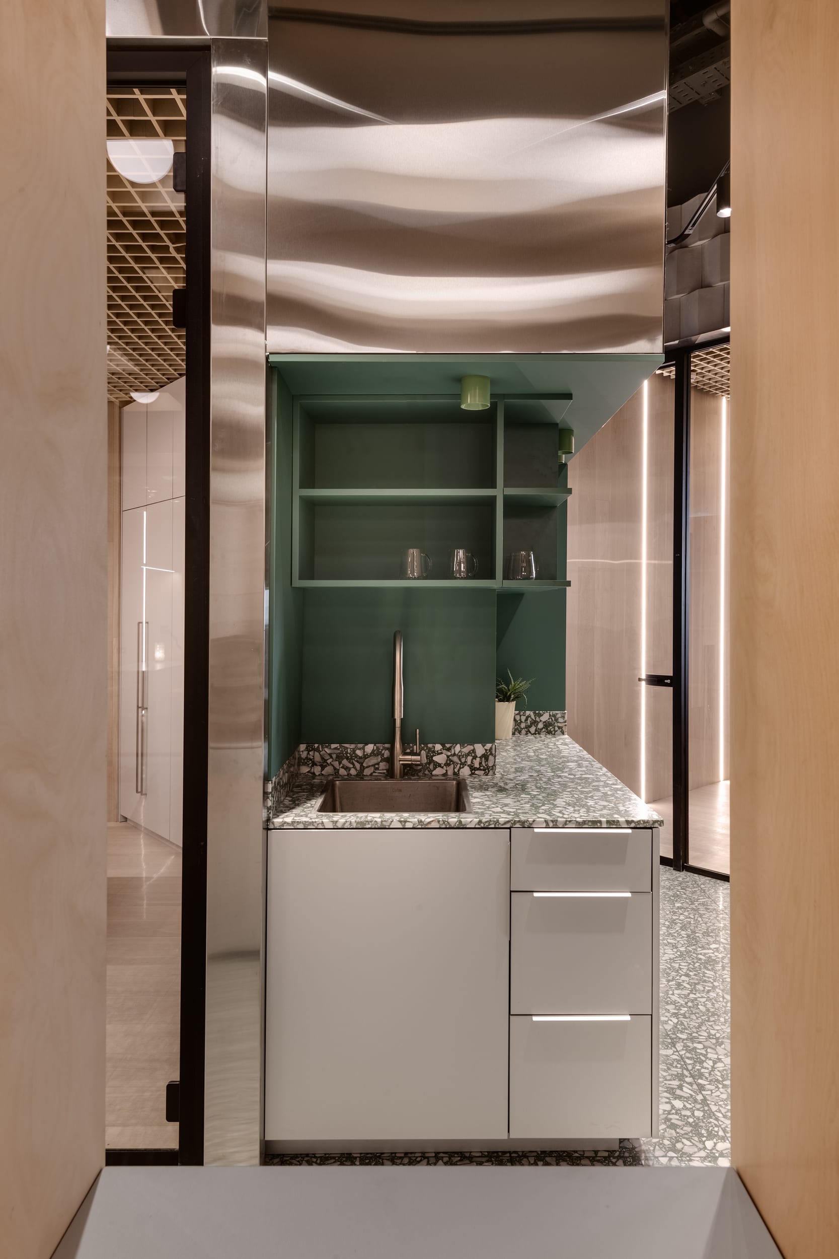 Tel Ad Office — interior material layering and wood finish